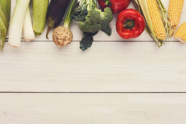 Border of fresh vegetables on wooden background with copy space - Foto, afbeelding