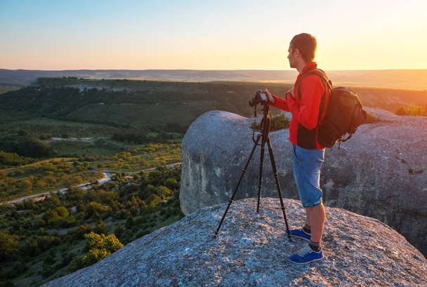 Photographer on top of mountain at sunset - Photo, Image