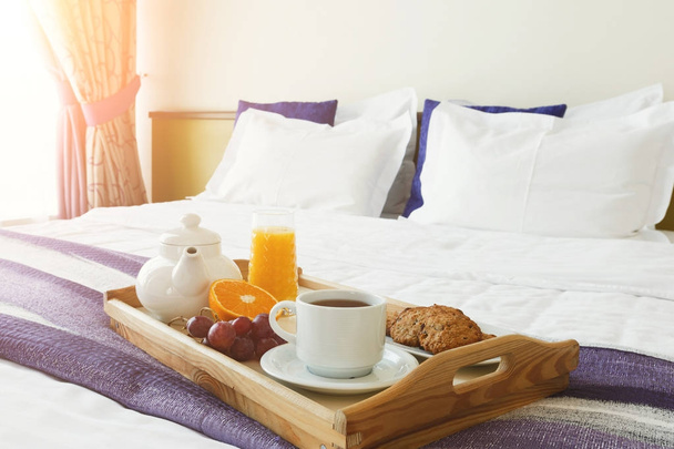 Breakfast served in bed on wooden tray - Photo, Image