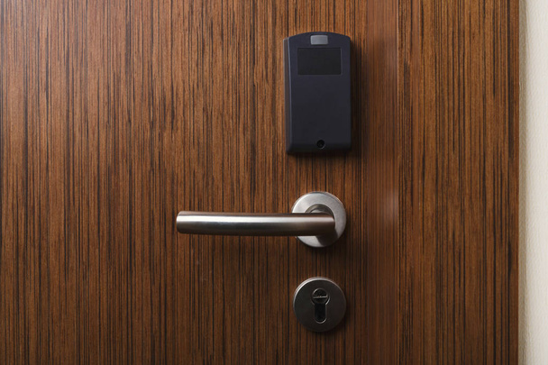 Hotel electronic card lock on wooden door - Photo, Image