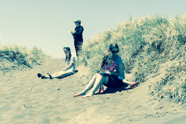 vier Frauen in den Dünen am Strand von Muriwai - Foto, Bild