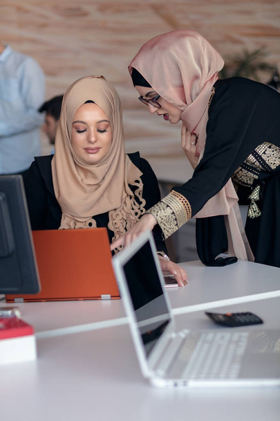 Business colleagues in hijabs looking at the computer monitor - 写真・画像