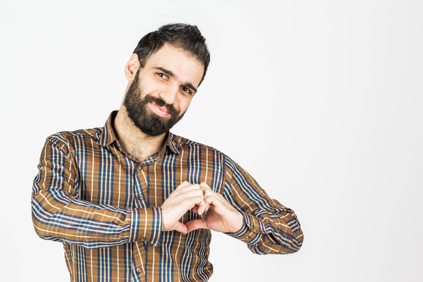 Man makes the heart out of the hands. on a white background. - Foto, afbeelding