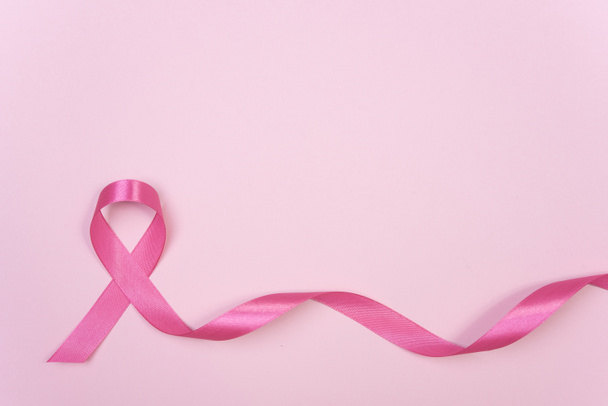 pink ribbon breast cancer on pink background. with copy space - Foto, imagen