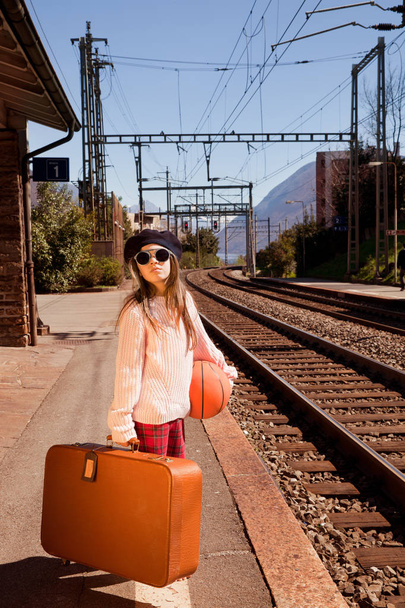 little girl waiting for the train in a deserted station, summer - Fotó, kép