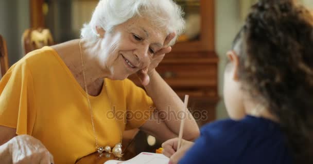 Senior Woman Helping Granddaughter With School Homework - Video, Çekim