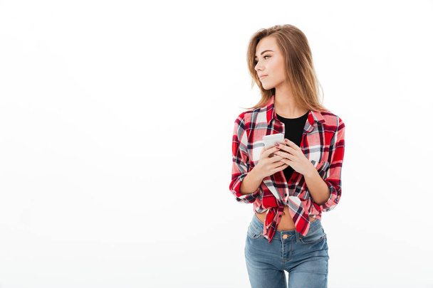 Portrait of a young sweet girl in plaid shirt - Foto, Imagen