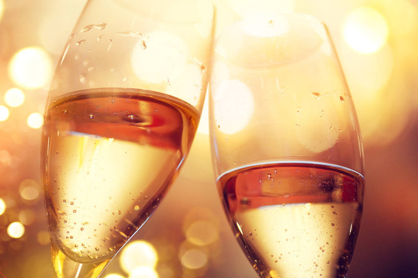 Glasses with champagne over holiday blinking background - Photo, Image
