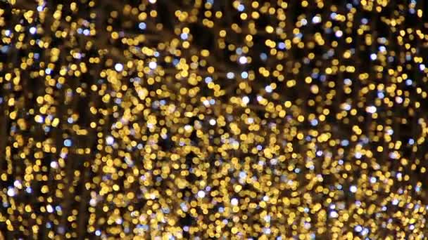Luces bokeh brillantes doradas de las decoraciones navideñas
 - Metraje, vídeo