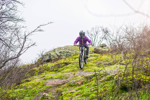 Downhill Cyclist Riding the Mountain Bike on the Rocky Trail, copy of free space. - Photo, Image