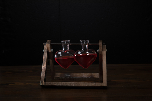 two heart shaped glass jars with rose perfume - Foto, Imagem