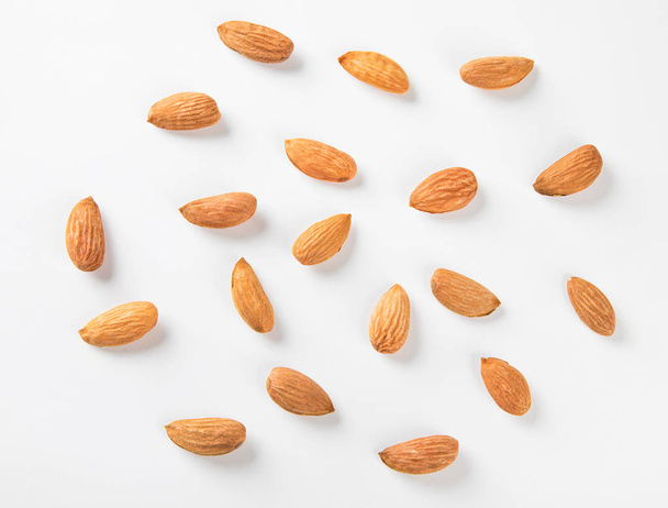 Almond nuts  on white - Φωτογραφία, εικόνα