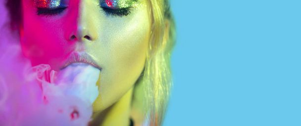 Fashion art portrait of woman in bright lights with colorful smoke - Φωτογραφία, εικόνα