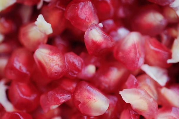 Delicious ripe pink pomegranate grains close up  - Photo, image