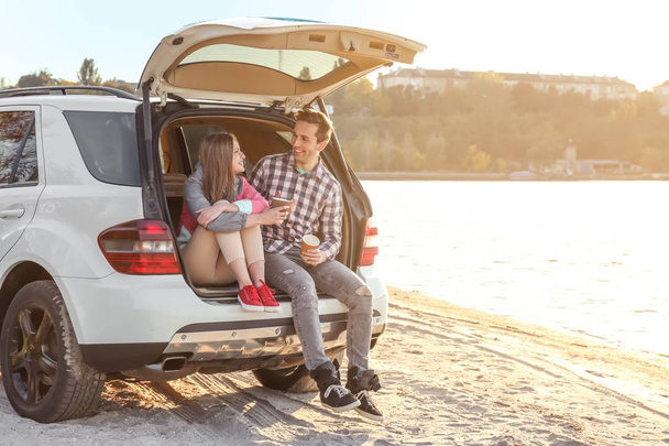 couple with coffee in car trunk - Foto, immagini