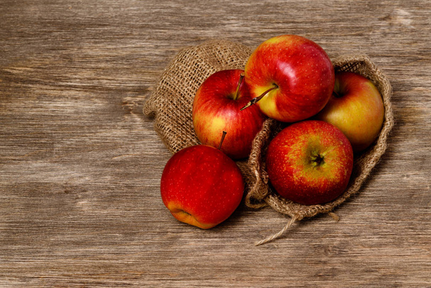 Juicy red apple on an old wooden background - 写真・画像