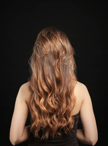 Woman with caramel highlights on black background - Foto, imagen