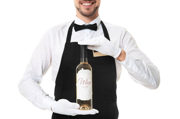 Handsome waiter with bottle of wine   - Photo, image