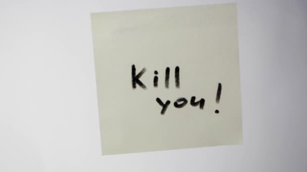 Επιγραφή σας σκοτώσει σε ένα κομμάτι χαρτί στο γυαλί, η έννοια της επιθετικότητας. Επιγραφή στο αυτοκόλλητο - Πλάνα, βίντεο