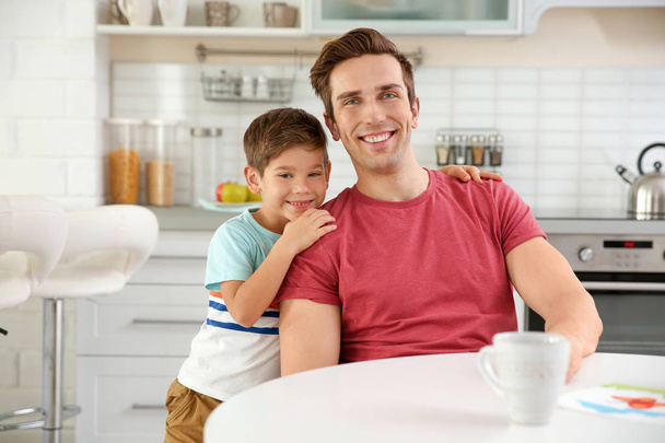 Portrait of happy father and son in kitchen - Foto, Imagem