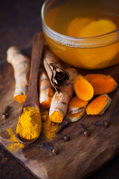 aromatic turmeric tea with cinnamon cloves and ginger - healthy eating - Photo, Image