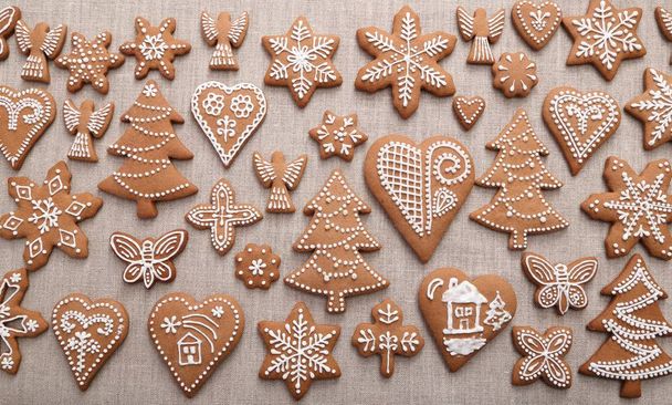 Christmas homemade gingerbread cookies on linen canvas. - Fotó, kép