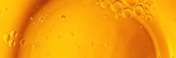 Oil and water bubbles, yellow background. - Photo, Image