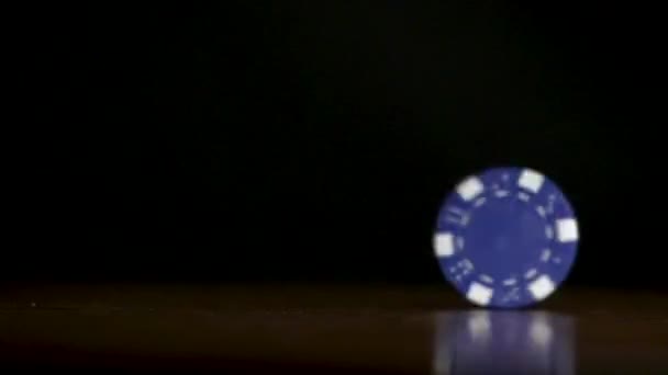 Poker chip spinning on the table. Casino theme. Poker game, poker chips on table, on black background - Footage, Video