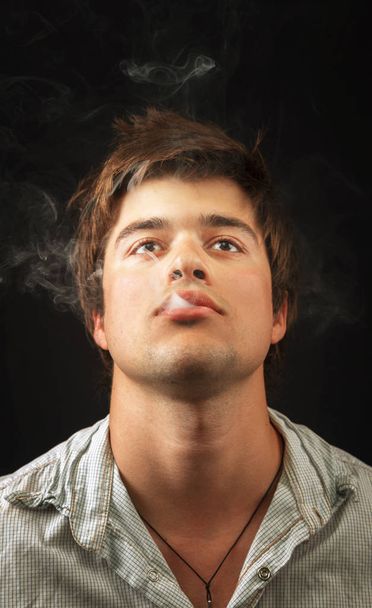 Young relaxed man smoking weed - Fotó, kép