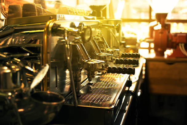 Espresso coffee machine on a counter in a cafe with sun flare back light - Φωτογραφία, εικόνα