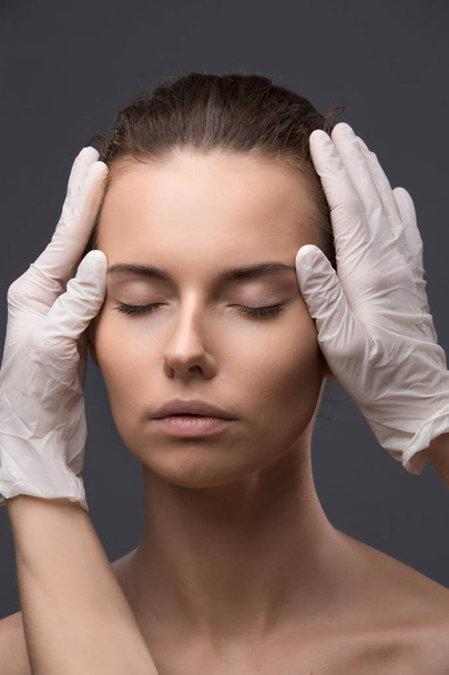 Portrait of young Caucasian woman getting cosmetic injection - Foto, imagen