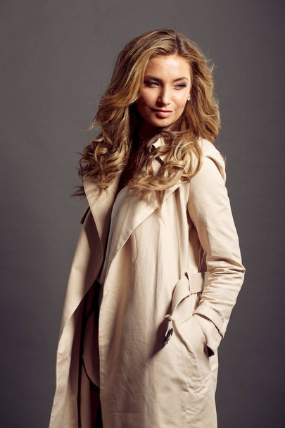 sexy girl with long blond hair in beige fur coat - Fotó, kép