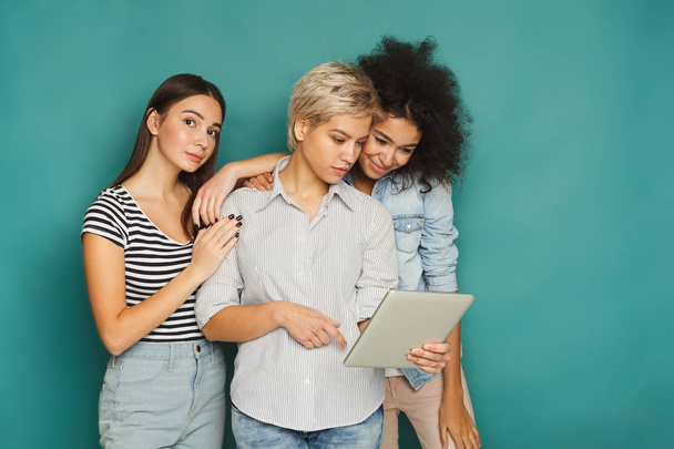 Three female friends using tablet in studio - Photo, Image