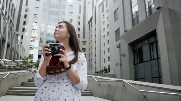 Slow motion video of happy smiling girl with long hair making photographs with camera - Felvétel, videó