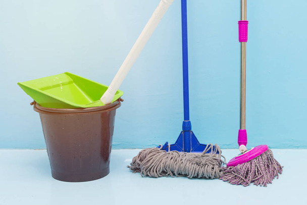 cleaning floor with wet mop and dustpan in room - Photo, Image