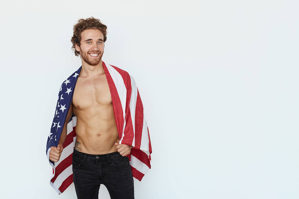 Handsome man posing with flag - 写真・画像