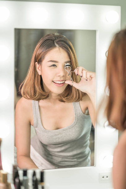 Young Beautiful Asian Woman making make-up near mirror - Fotografie, Obrázek