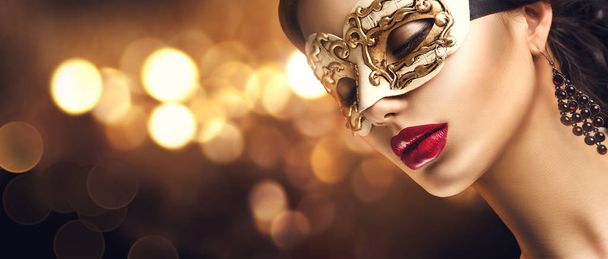woman in golden masquerade carnival mask with bokeh on background - Foto, Imagem