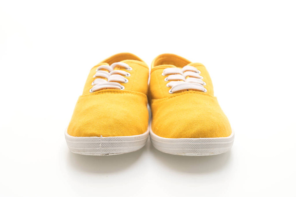 yellow sneakers on white background - Foto, imagen