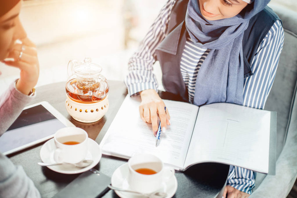 beautiful Muslim woman working with documents. business, lifestyle concept - 写真・画像