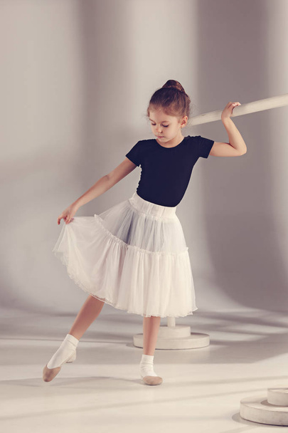 The little balerina dancer on gray background - Fotoğraf, Görsel