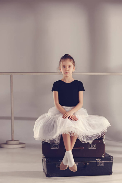 The little girl as balerina dancer sitting at studio - Фото, изображение