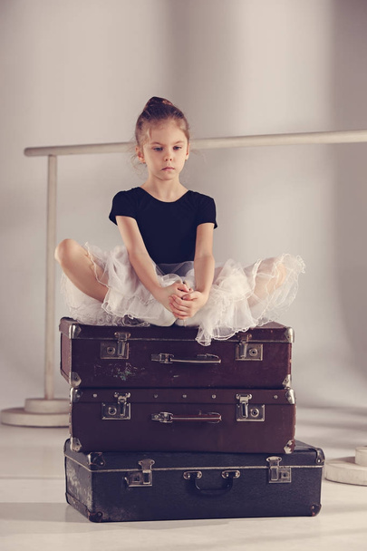 The little girl as balerina dancer sitting at studio - Valokuva, kuva