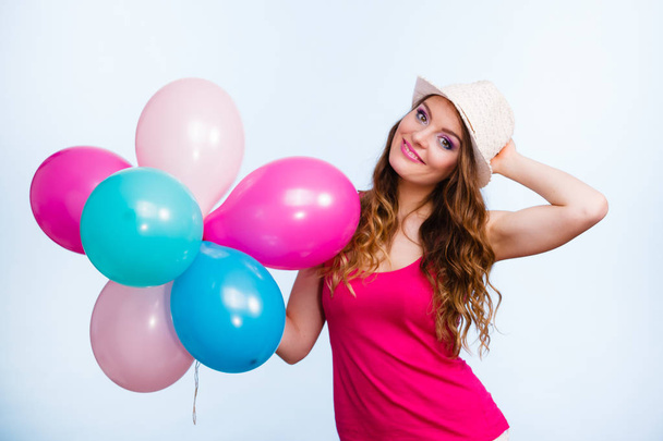 Woman playing with many colorful balloons - Foto, afbeelding