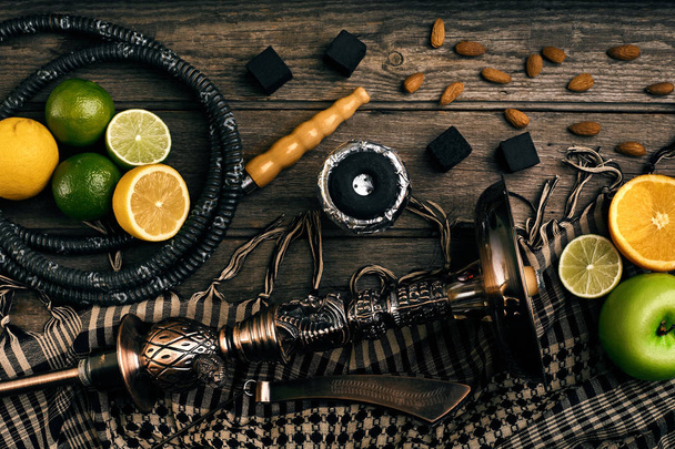 Stylish Smoking hookah and basket with lemon, lime and orange on - Photo, image