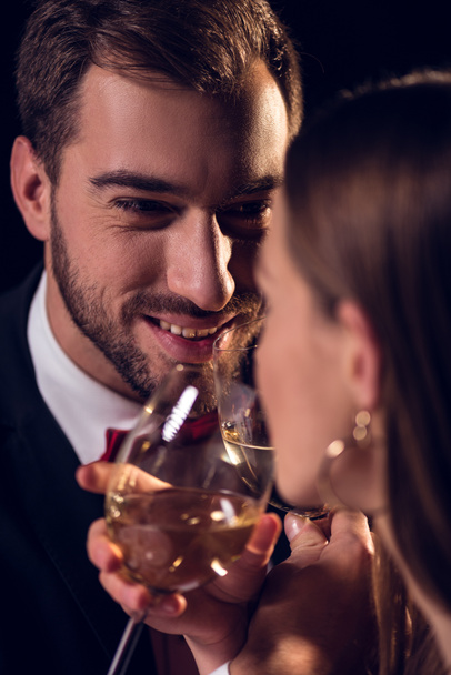 happy couple drinking white wine on romantic date in restaurant - Fotografie, Obrázek