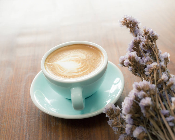 Cup of hot latte art coffee on wooden table - Фото, зображення