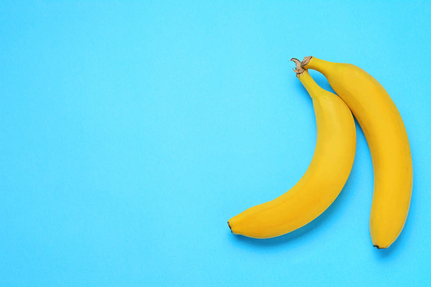 Top view of sweet bananas on light blue background - Foto, Bild