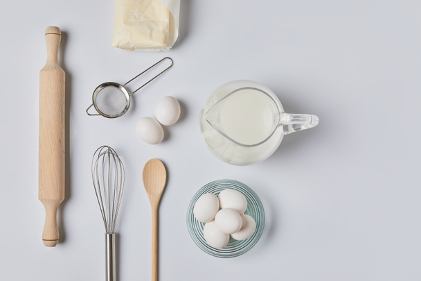 top view of eggs and milk on white table - Photo, Image