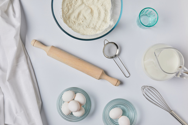 top view of ingredients for dough and tablecloth on table - Foto, Imagen
